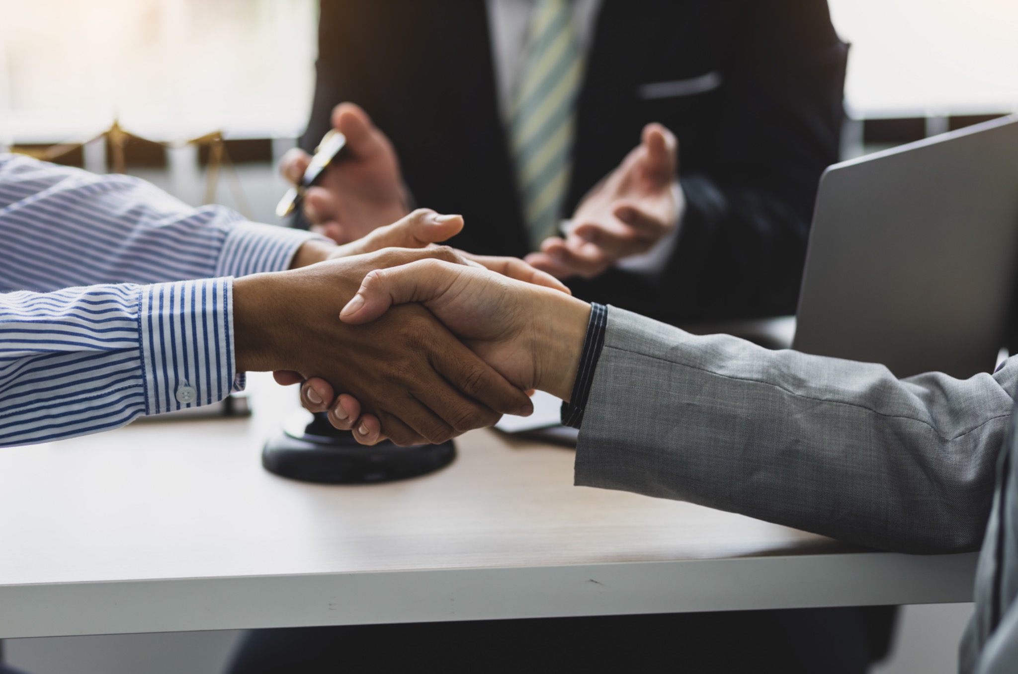Professional handshake representing mediation and resolution